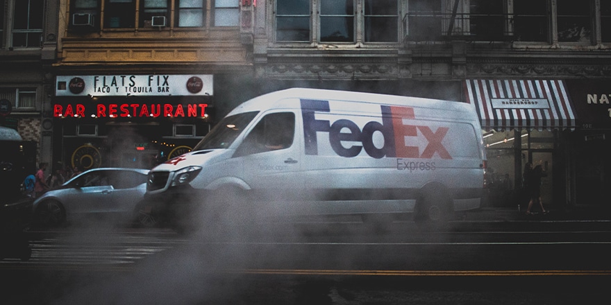 Fedex truck on street with smoke on the side 